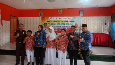 Simbolis penyerahan seragam batik gratis bermotif khas daerah kepada siswa SD oleh Ketua DPRD Kendal Mahfud Shodiq