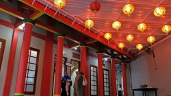 Jemaah berjalan memasuki serambi Masjid Al Mahdi Magelang yang memiliki arsitektur unik mirip kelenteng dengan dominasi warna merah dan hijau.
