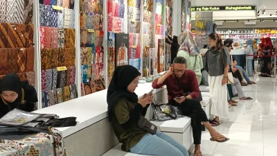 Suasana wisatawan dan pemudik berbelanja pakaian di toko Batik Benang Raja Kudus menjelang Lebaran.