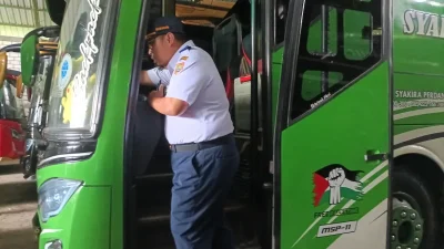 Petugas Dishub Pati mengecek kesiapan mesin dan kelengkapan bus mudik Lebaran di garasi