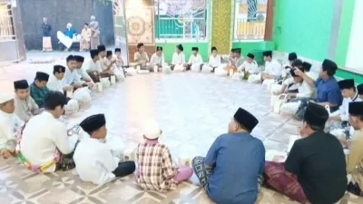 Sekelompok anak yatim piatu sedang duduk di serambi masjid mengikuti kegiatan pesantren kilat Ramadan bersama mahasiswa.